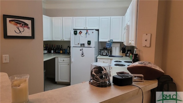 kitchen featuring white cabinets, white appliances, and light tile patterned flooring