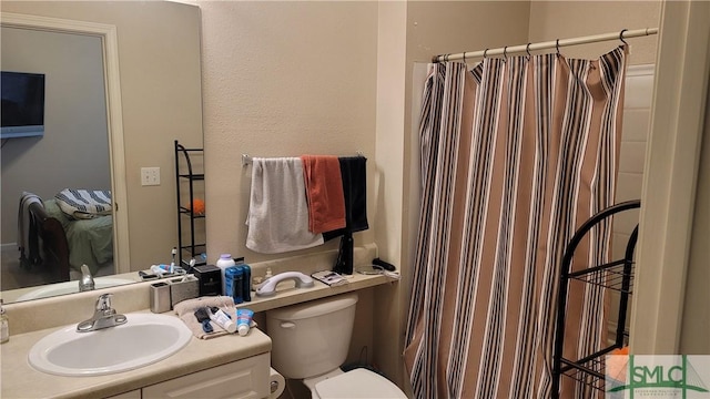 bathroom with a shower with curtain, toilet, and sink