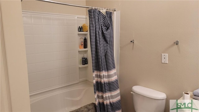 bathroom featuring shower / bath combination with curtain and toilet