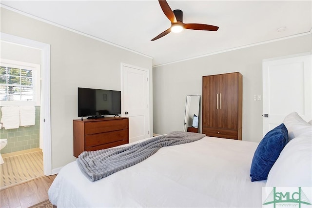 bedroom featuring ensuite bath, ceiling fan, and light hardwood / wood-style flooring