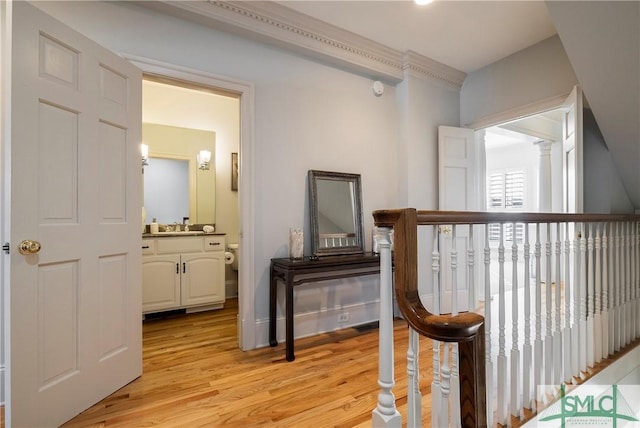 corridor featuring light hardwood / wood-style flooring and sink