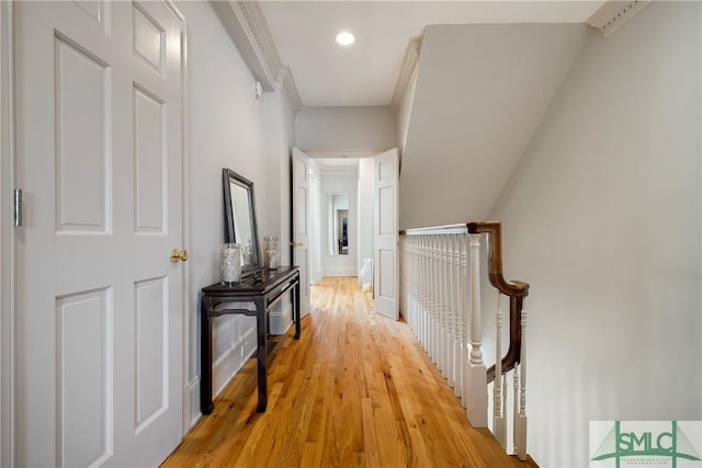 hall with crown molding and light wood-type flooring