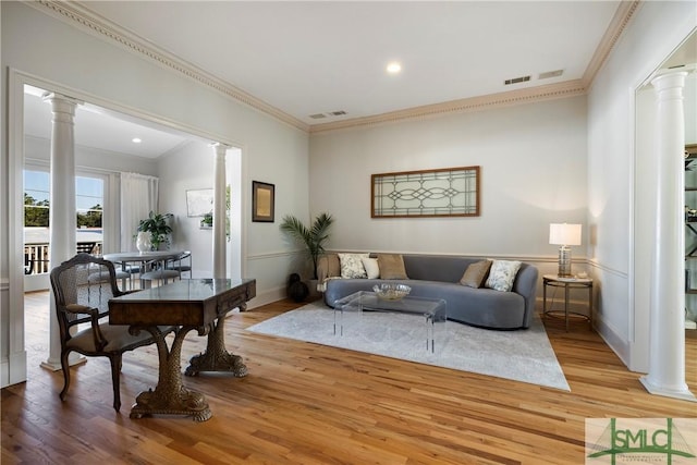 living room with ornate columns, light hardwood / wood-style flooring, and ornamental molding