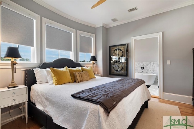 bedroom with hardwood / wood-style flooring, ceiling fan, crown molding, and connected bathroom