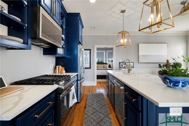 kitchen with blue cabinetry, sink, stainless steel appliances, and dark wood-type flooring