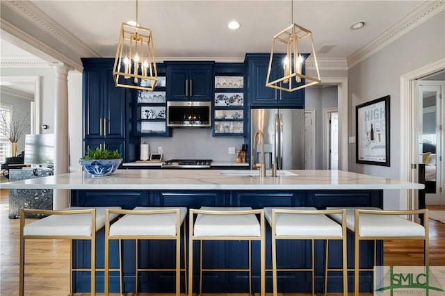 kitchen featuring a spacious island, blue cabinets, crown molding, and appliances with stainless steel finishes