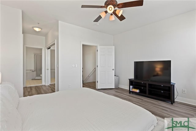 bedroom featuring hardwood / wood-style floors, ensuite bath, and ceiling fan