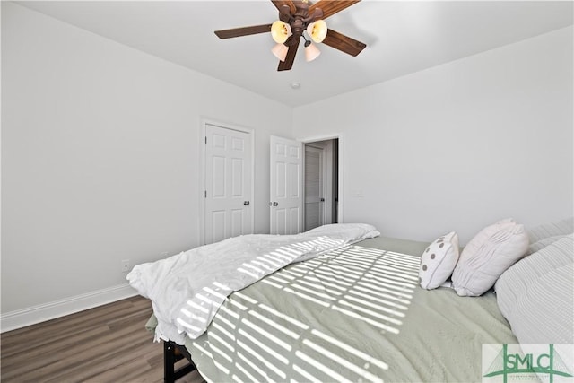 bedroom with ceiling fan and wood-type flooring