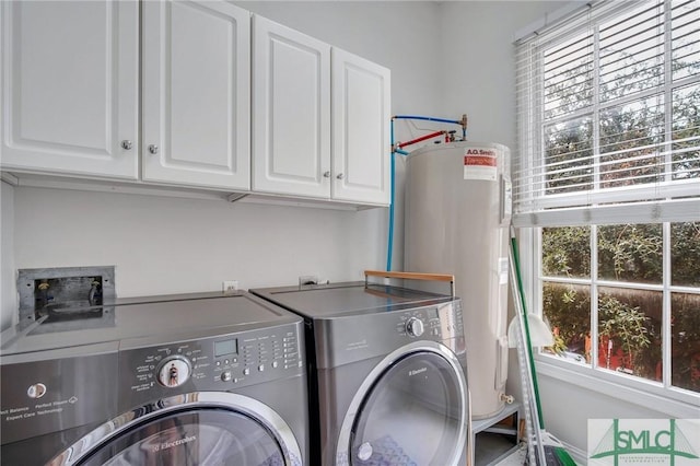 washroom featuring plenty of natural light, cabinets, separate washer and dryer, and water heater