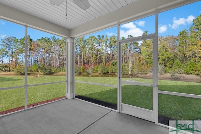 unfurnished sunroom with ceiling fan and plenty of natural light