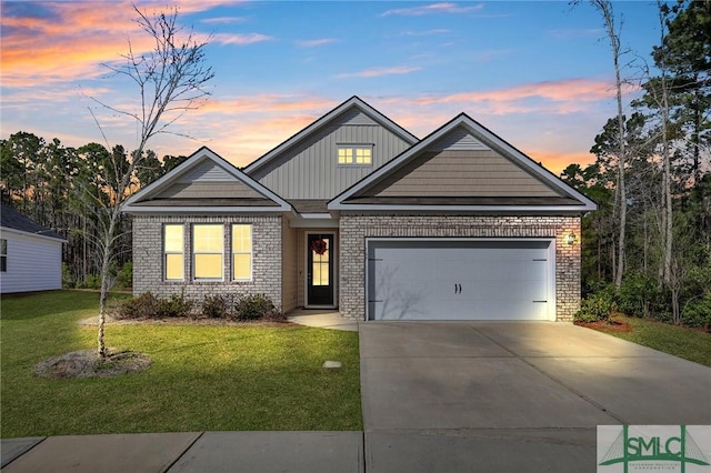 view of front of home with a garage and a yard