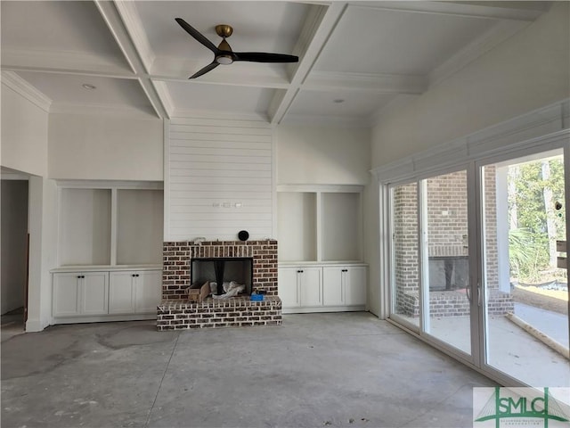 unfurnished living room with ceiling fan, coffered ceiling, a brick fireplace, beamed ceiling, and ornamental molding