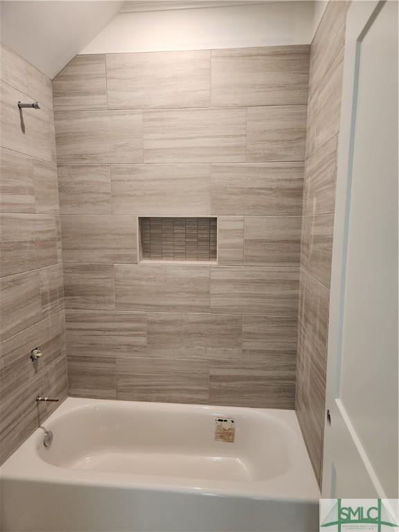 bathroom featuring tiled shower / bath