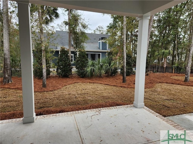 view of yard featuring fence and a patio