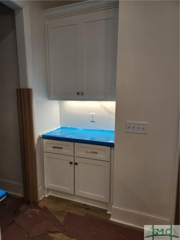 interior space with dark wood-style floors and baseboards