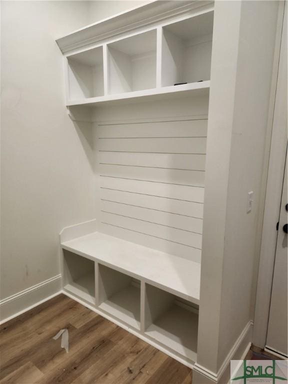 mudroom featuring wood finished floors and baseboards