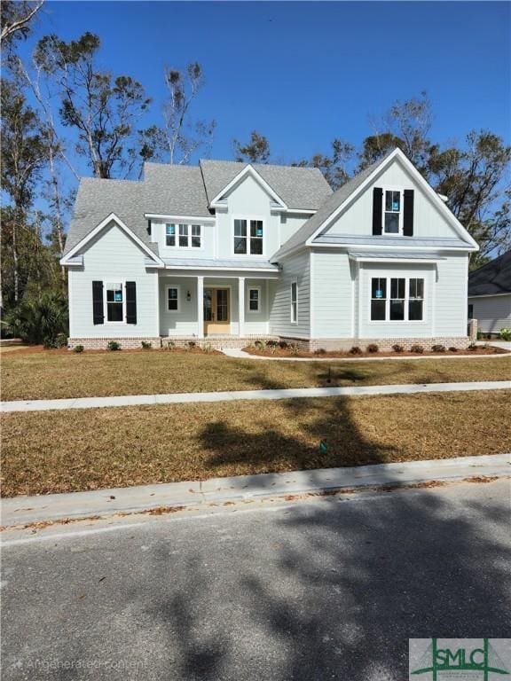 modern inspired farmhouse with a front lawn and a porch