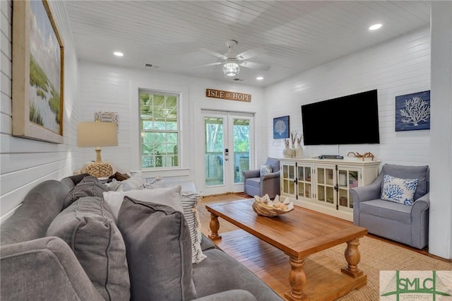 living room featuring french doors and ceiling fan