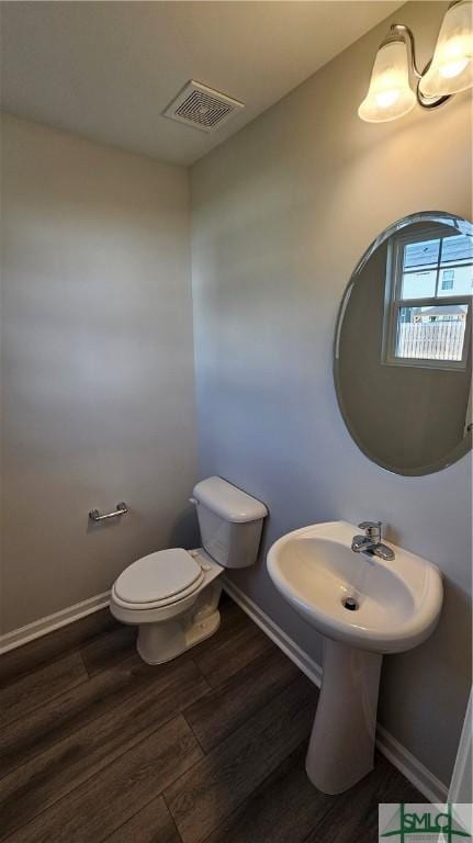 bathroom featuring hardwood / wood-style floors and toilet