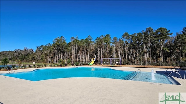 150 Cross Creek Dr, Pooler, GA 31322 - community pool featuring a patio and a wooded view