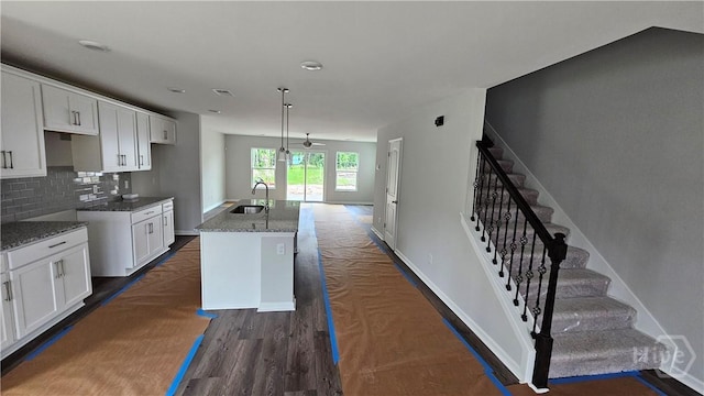 150 Cross Creek Dr, Pooler, GA 31322 - kitchen featuring a sink, a center island with sink, white cabinetry, and decorative backsplash