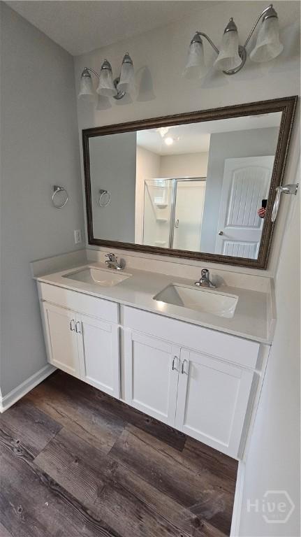 150 Cross Creek Dr, Pooler, GA 31322 - bathroom with double vanity, wood finished floors, and a shower with door