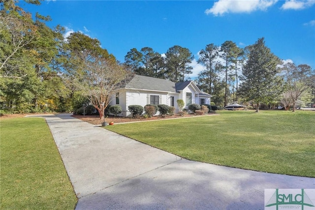 view of front of property featuring concrete driveway and a front lawn