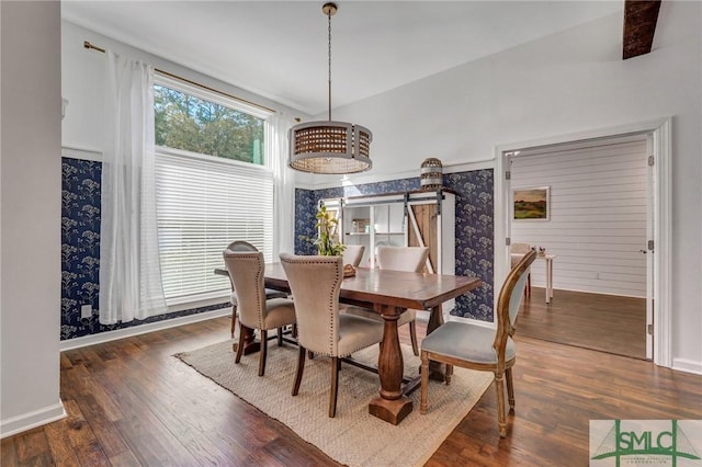 dining room with baseboards and hardwood / wood-style flooring