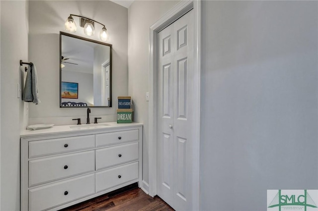 bathroom featuring ceiling fan, wood finished floors, and vanity