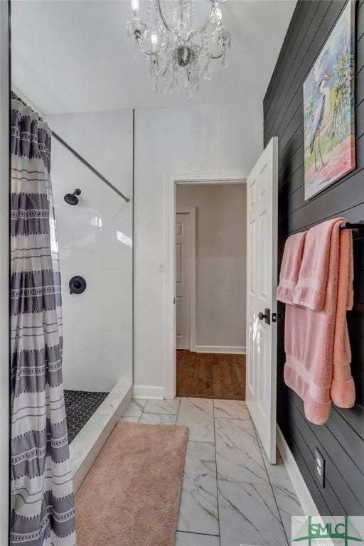 bathroom with curtained shower, baseboards, marble finish floor, and an inviting chandelier