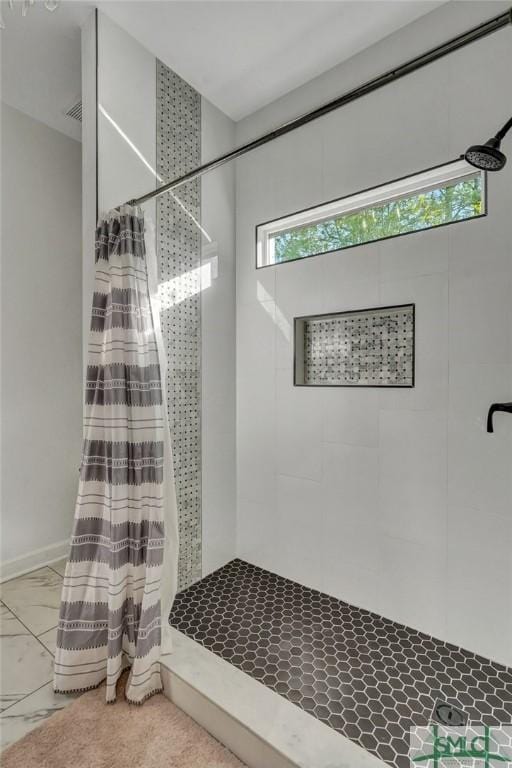 bathroom featuring visible vents and tiled shower