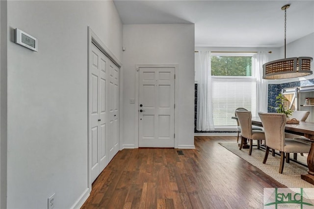 entryway featuring dark wood-style floors and baseboards