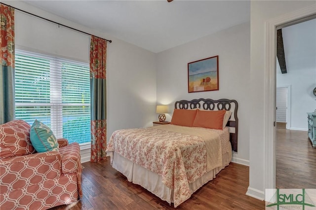 bedroom featuring baseboards and wood finished floors