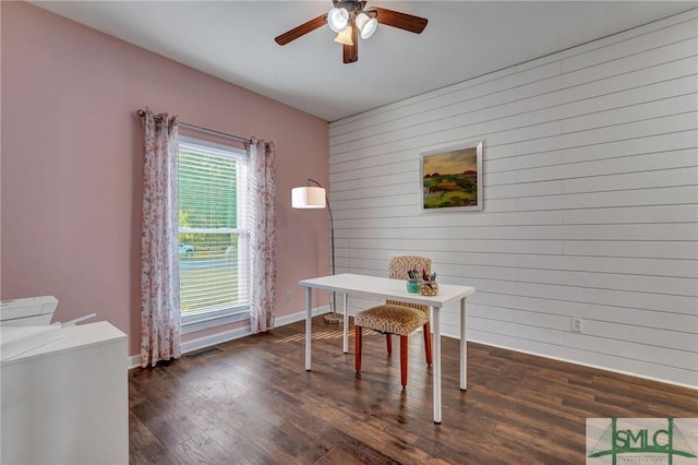 office space featuring dark wood-style floors, visible vents, baseboards, and ceiling fan