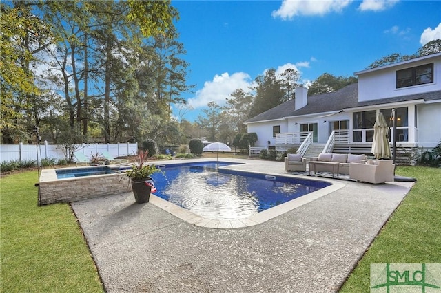 view of pool with an outdoor living space, a yard, a patio area, and an in ground hot tub