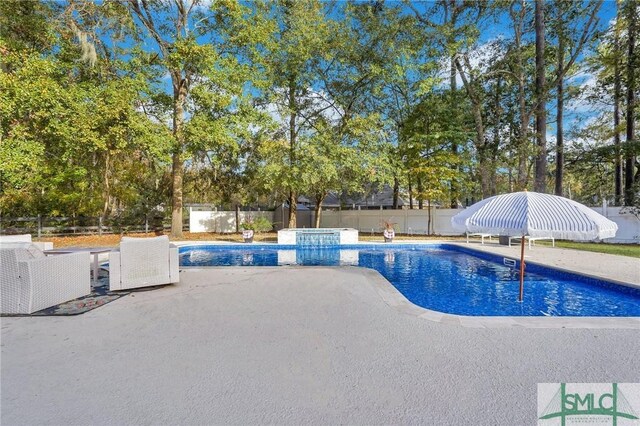 view of pool featuring a patio, a fenced backyard, and a fenced in pool