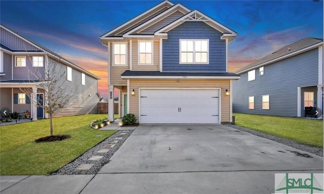 view of front facade with a yard and a garage