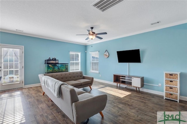 living room with a textured ceiling, dark hardwood / wood-style floors, ceiling fan, and crown molding