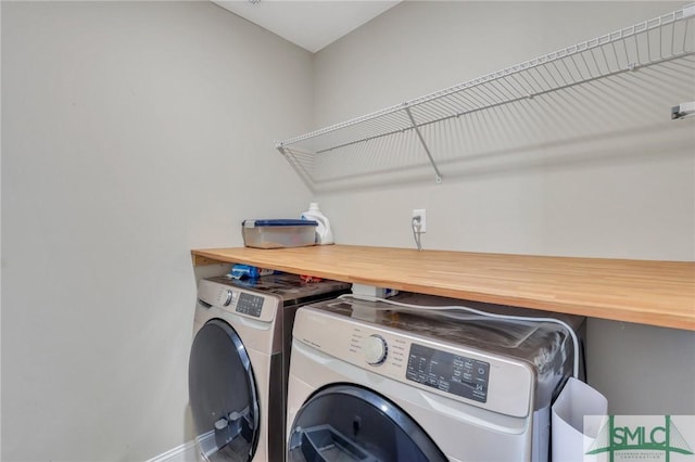 clothes washing area with separate washer and dryer