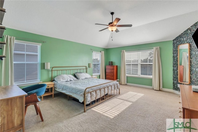 carpeted bedroom with vaulted ceiling and ceiling fan