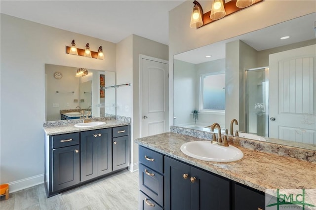 bathroom with vanity and a shower with shower door