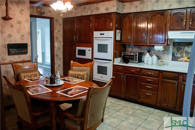 kitchen with light tile patterned floors and white appliances