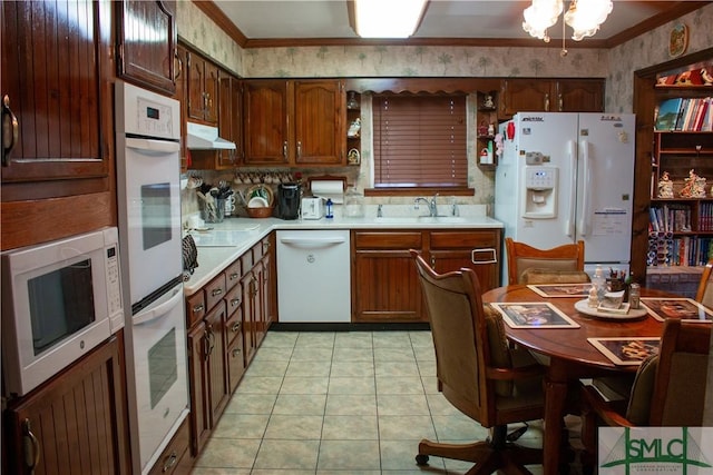 kitchen with white appliances, sink, light tile patterned floors, and ornamental molding