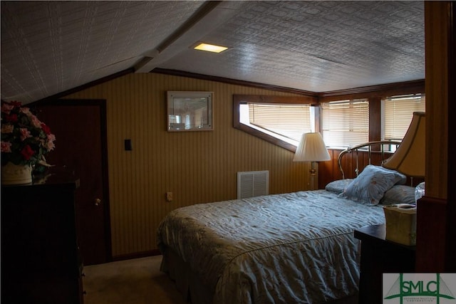 carpeted bedroom featuring lofted ceiling with beams