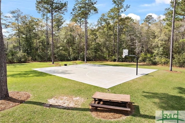 view of basketball court featuring a lawn