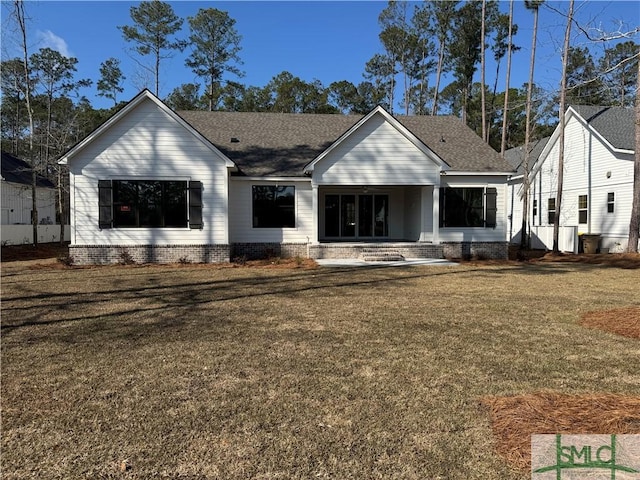 view of front of house with a patio area and a front yard