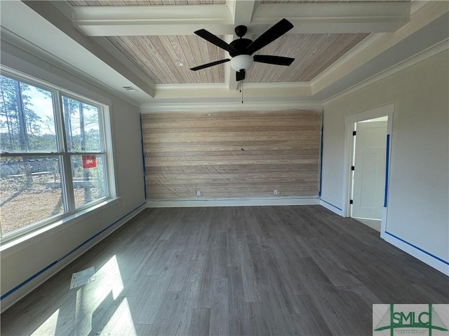 empty room featuring wood ceiling, crown molding, a tray ceiling, dark hardwood / wood-style flooring, and beam ceiling