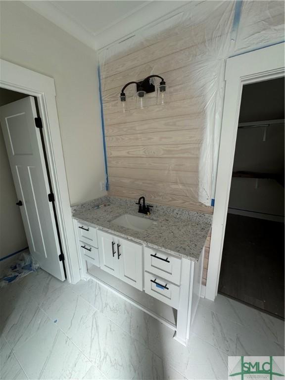 bathroom with vanity, a shower, and crown molding