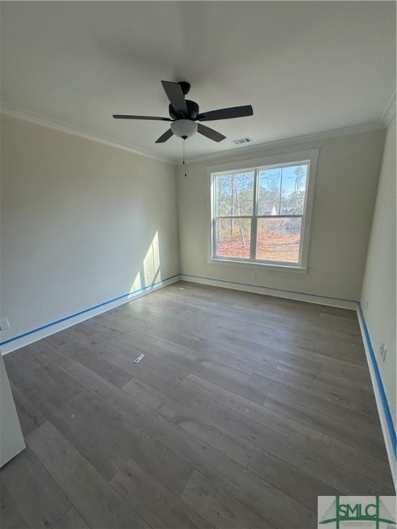 empty room with crown molding, wood-type flooring, and ceiling fan