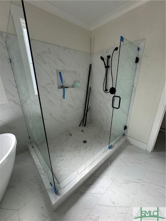 bathroom featuring ornamental molding and shower with separate bathtub